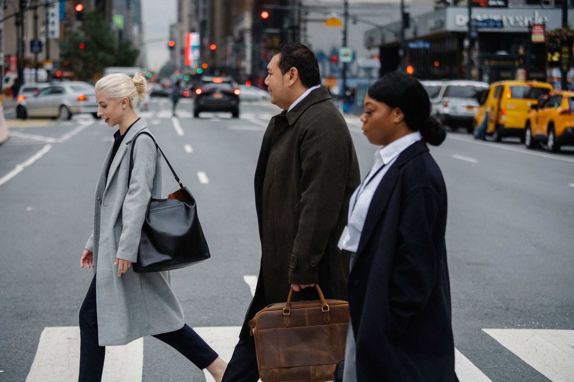 Office workers walking through busy city street downtown