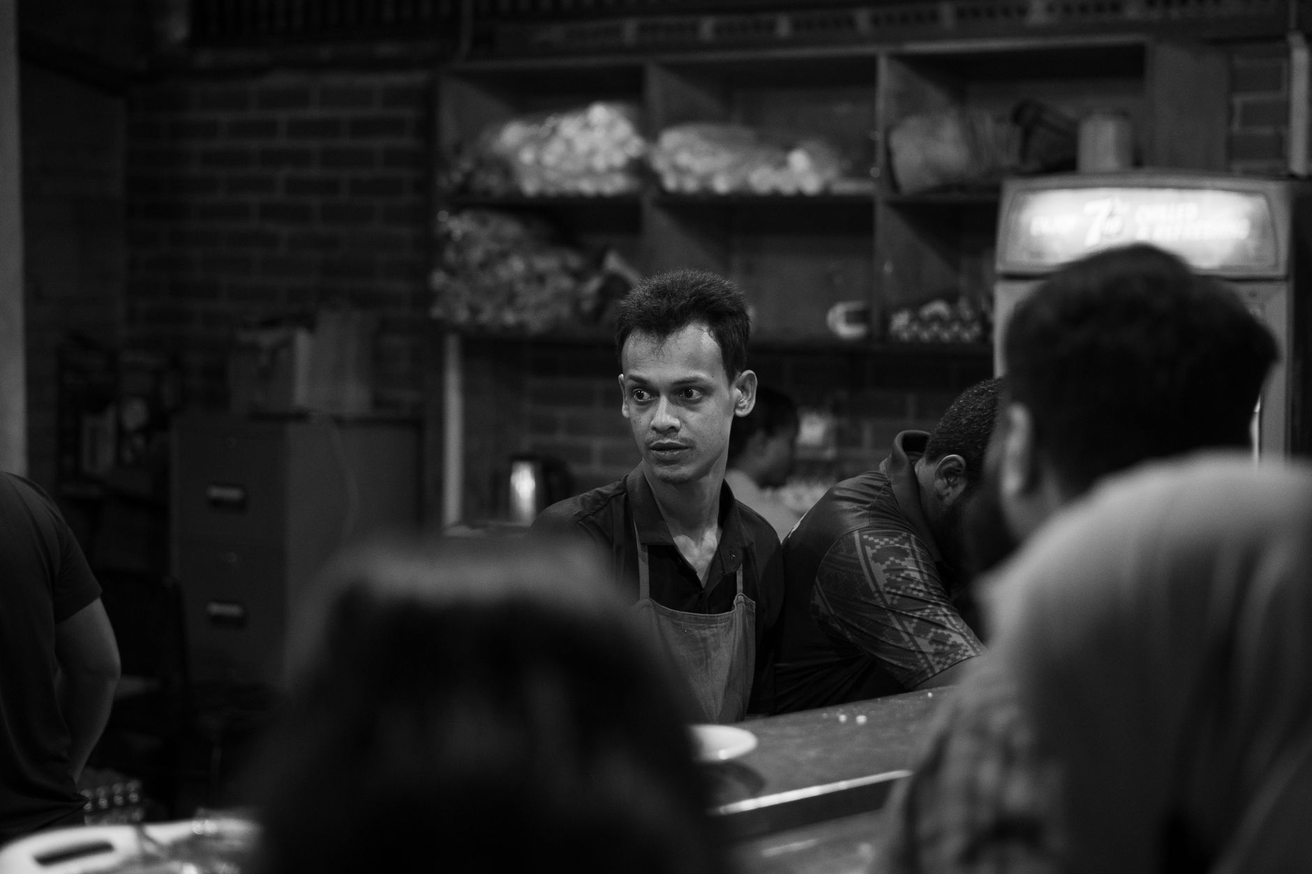 restaurant workers serving customers at busy dining tables